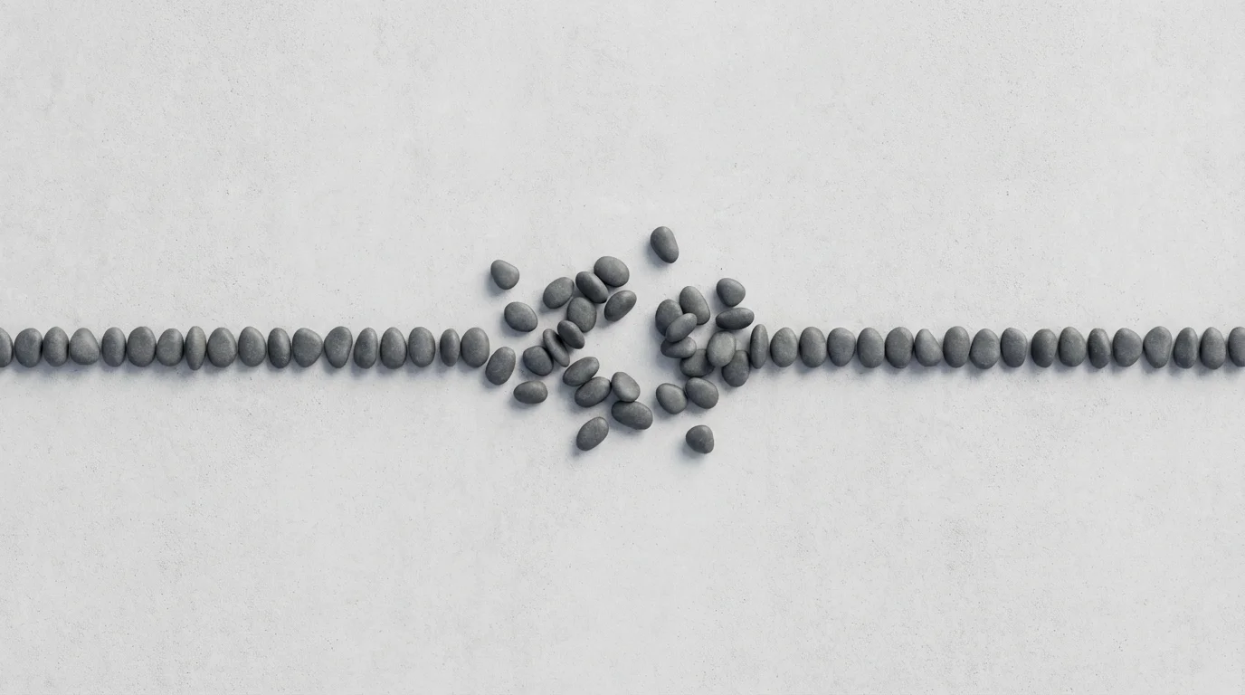 Flat lay of an interrupted line of stones symbolizing streaming buffering.